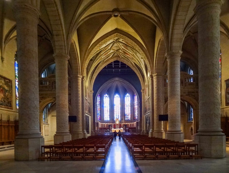 people walking through a large cathedral