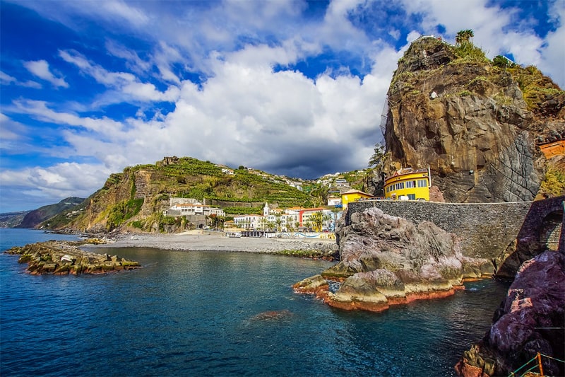 a small colorful village by the sea