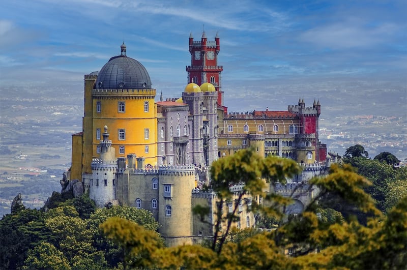 an ornate castle in several different styles and colors, which is one of the best places to visit in Portugal