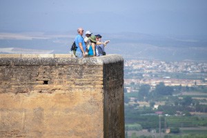 people in a large fort looking across the countryside