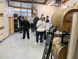 people in a room with large wine barrels in Seattle Southside