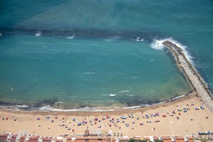 a crowd on Sandy Beach, seen from the air