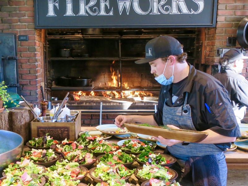chef preparing salads at The Firewrks feast, one of the best restaurants in pei / Prince Edward Island