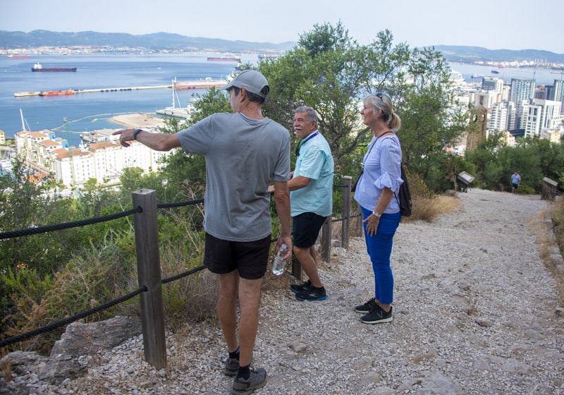 a guide pointing out sights in the city below - one of the things to do in Gibraltar