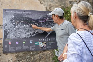 man pointing at a spot on a trail map