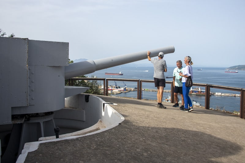 people by World War 2 cannon at the rock of Gibraltar - one of the things to do in Gibraltar