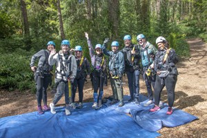 a group of people gearing up for a zipline tour