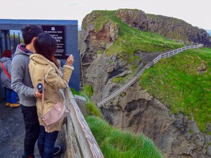 people looking at a bridge over a deep gully - seen on a black taxi tour of Belfast