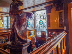 people sitting at a table in an ornate old restaurant 