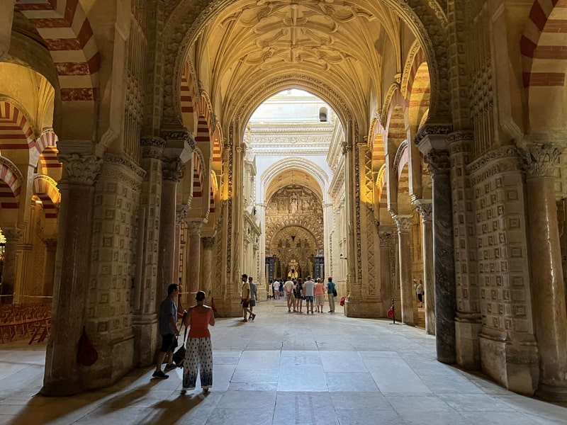 people walking through an ancient mosque