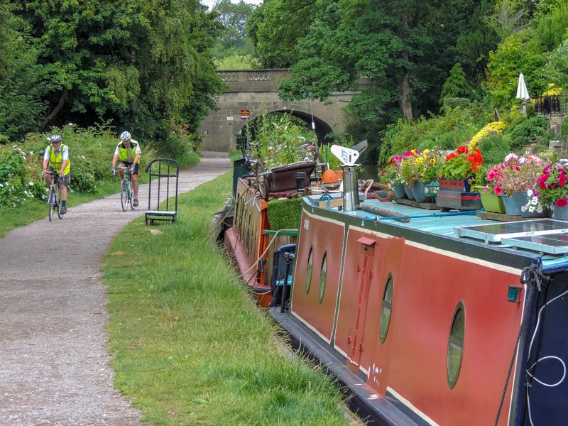 canal boats with flower pots on their roofs