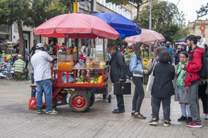 people ordering from a food cart -  what to do in Bogota