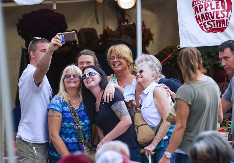 people taking a selfie at a fall festival