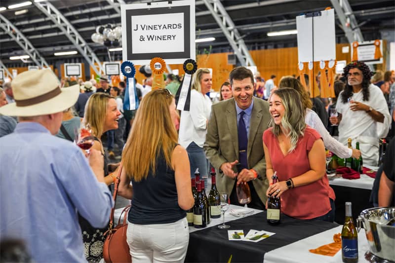 people sampling wines at a festival
