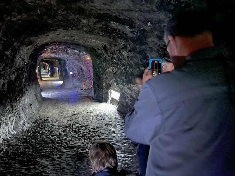 people taking photos in a salt mine