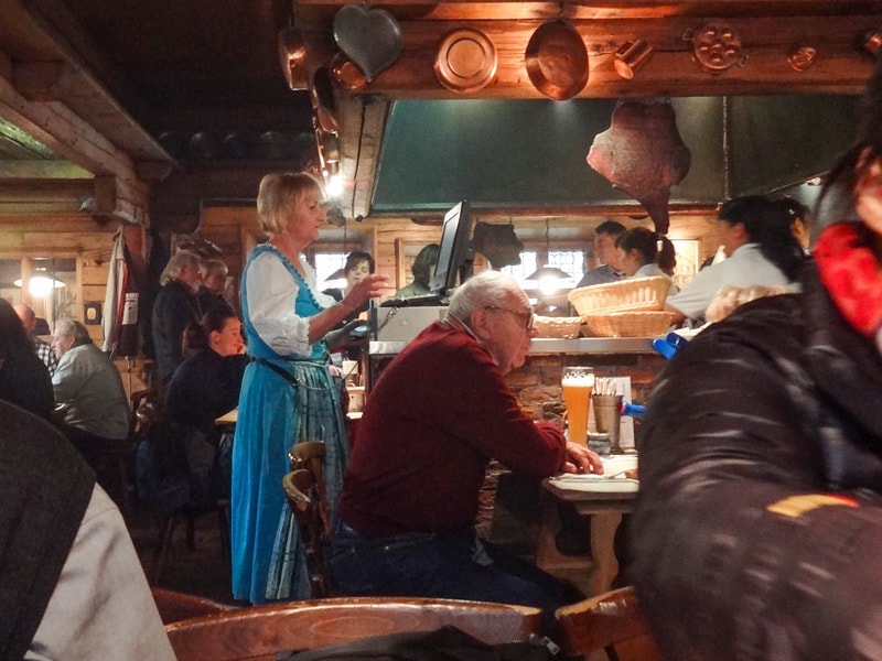 people sitting at tables in a crowded restaurant