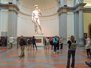 People looking at the statue of David in Florence - one of the Top 10 Places to Visit in Italy