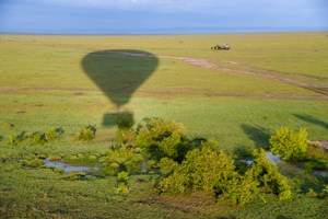 the shadow of a hot-air balloon on the savanna 