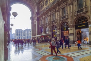 people walking through a large, ornate shopping arcade