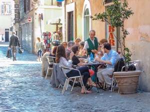 people seated in an outdoor cafe in Rome - one of the Top 10 Places to Visit in Italy