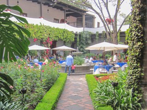 an outdoor restaurant with large umbrellas over the tables