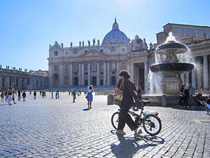 a woman with a bike in St. Peter's Square - one of the Top 10 Places to Visit in Italy