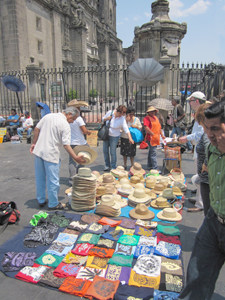 people buying hats from street vendors