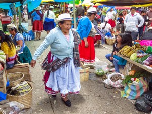 a woman walking through a busy marketplace
