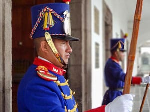 guards in bright blue dress at attention at a presidential palace