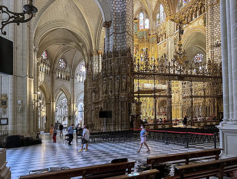 people walking through a large cathedral seen on a Toledo from Madrid day trip