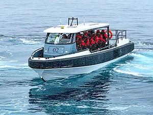 people in red jackets on a boat on an expedition in Antarctica