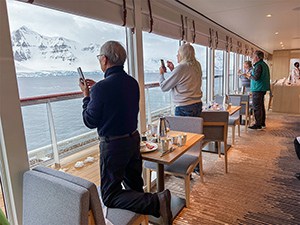 people taking photos from a ship's windows on an expedition in Antarctica