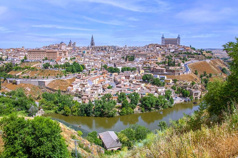 a large city beyond a river seen on a Toledo from Madrid day trip