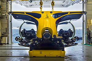 a small yellow submarine siting in a hangar