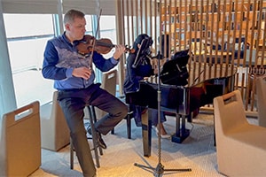 a violinist and pianist performing on an expedition in Antarctica