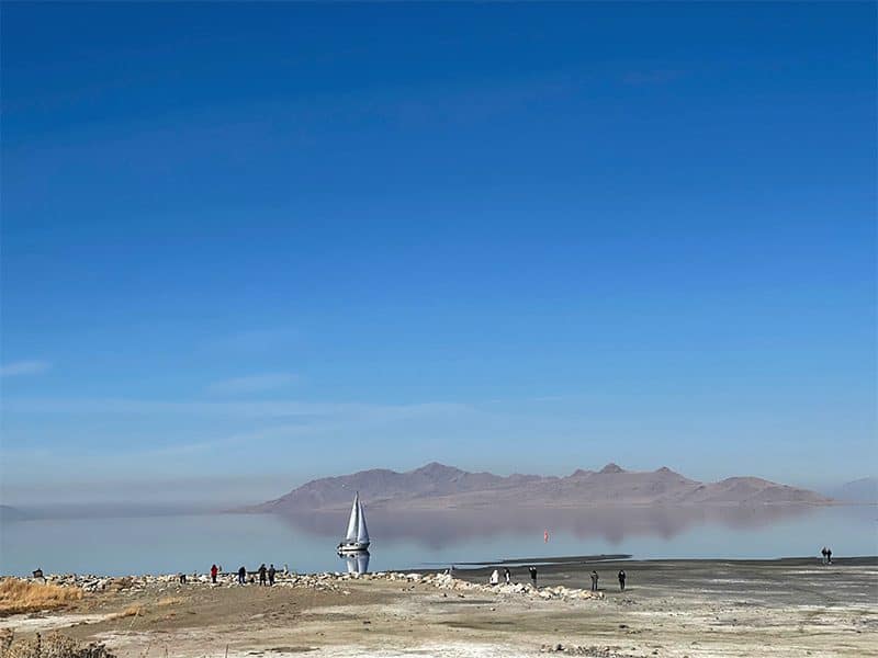 people looking at a sailboat on the Great Salt Lake, one of the things to do in salt lake city