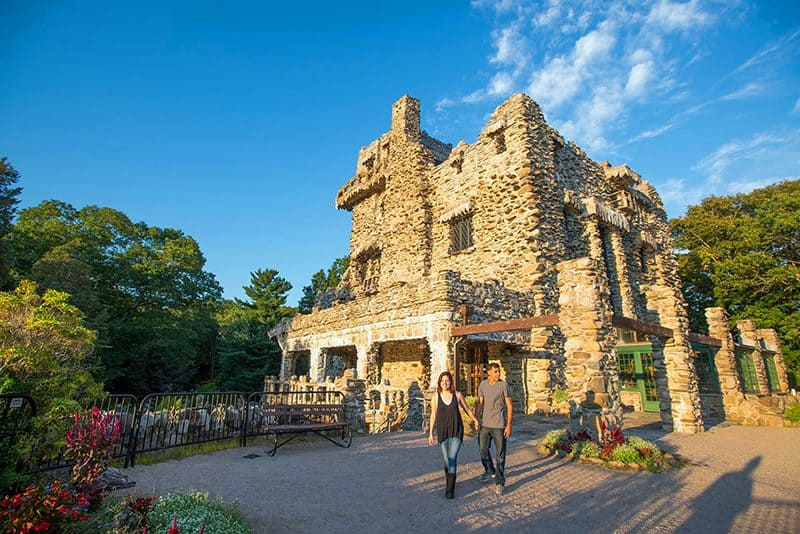 a couple walking outside an old castle, one of several castles in the USA