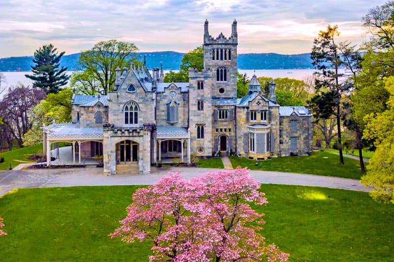 a beautiful mansion with trees in bloom