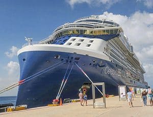 the bow of the Celebrity Beyond alongside a pier