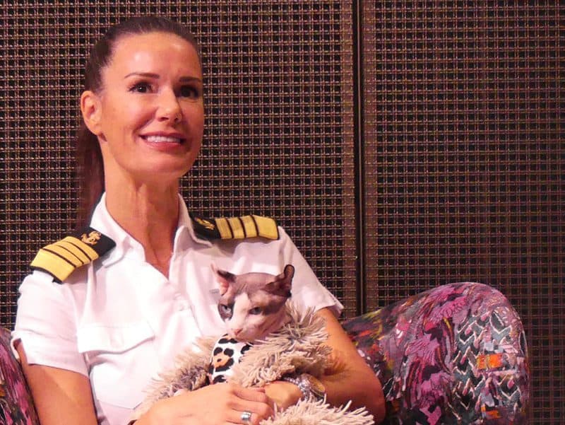 a female ship's captain holding a cat