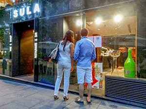 a couple standing outsde a restaurant - one of Madrid's Hidden Gems