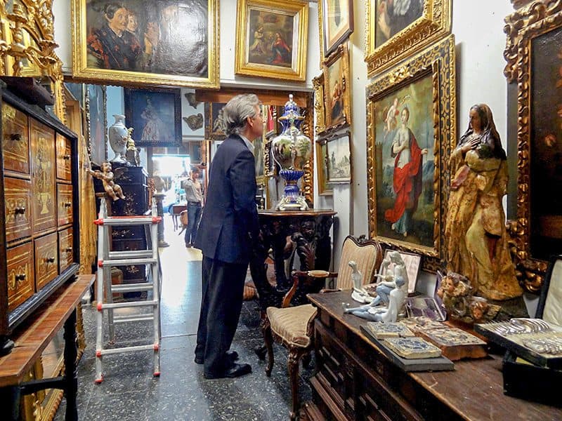 a man in an antique shops that's one of Madrid's Hidden Gems