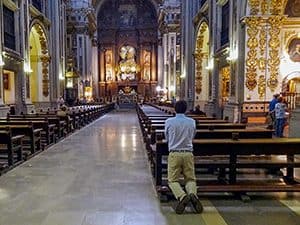 a man kneeling in a old church