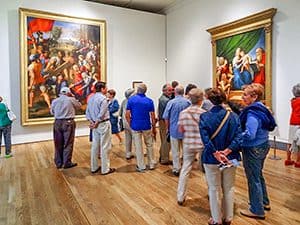 people looking at an exhibit in the Prado Museum