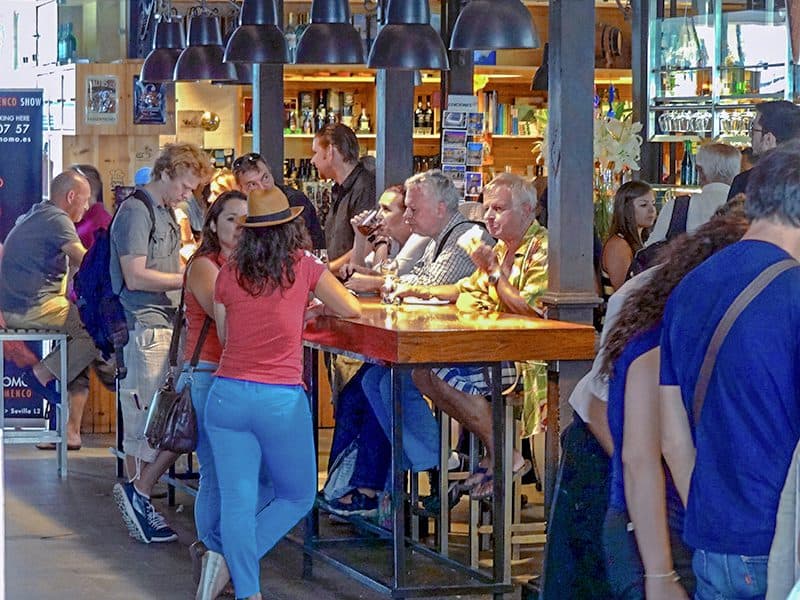 people at a communcal dining table in Mercado Sa, Miguel - one of Madrid's Hidden Gems