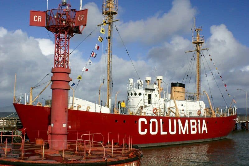 a ship with a red hull with teh name Columbia on its side