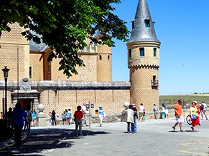 people in front of an old castle in Segovia