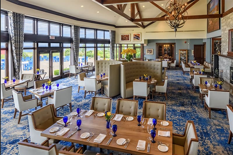 a restaurant with bright blue glasses on the tables