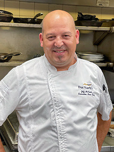 a chef smiling at the camera