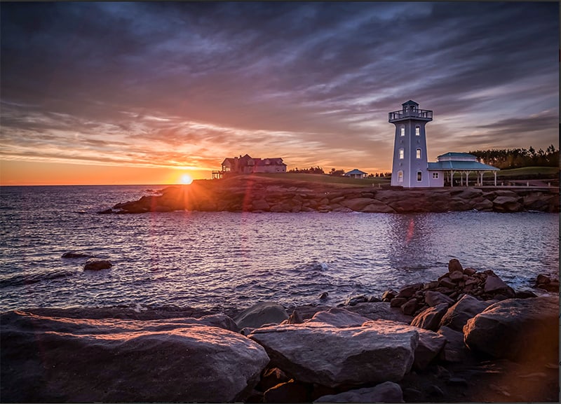 a lighthouse at the Fox Harb’r Resort at sunset